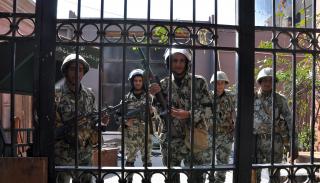 Soldiers behind a gate during the 2011 Egyptian Revolution