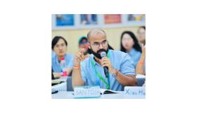 Santosh Kumar holding a mic and talking at a climate summit