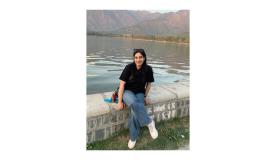 Mir Wafa Rasheeq sat by a lake and mountains