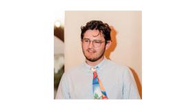 Photo of Chris Saltmarsh in a white shirt and multicoloured tie