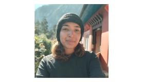 Aishwarya Sanas wearing a jumper and beanie hat
