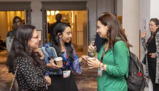 Three BISA conference delegates networking in Glasgow