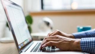 Male hands on laptop