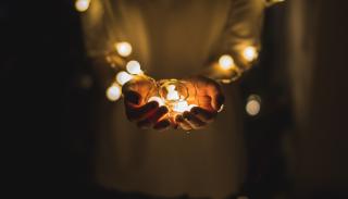 Hands holding a string of lights