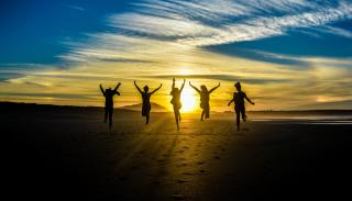 Five people jumping for joy