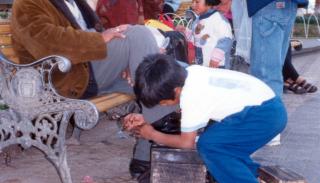 Young boy shining shoes in Bolivia