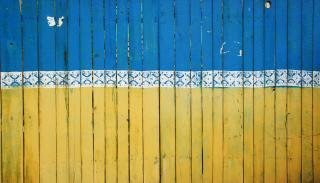 The yellow and blue wooden fence of a construction site in Kiev
