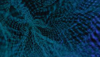 An abstract shot of a blue mesh against a dark background, representing a digital network
