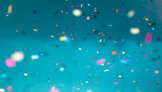Celebration image, blue background with multicoloured confetti