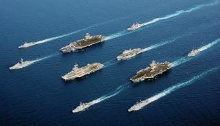 Four modern aircraft carriers of various types—USS John C. Stennis, Charles de Gaulle (French Navy), USS John F. Kennedy, helicopter carrier HMS Ocean—and escort vessels, 2002