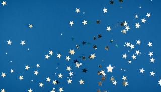 Blue background with silver star-shaped confetti