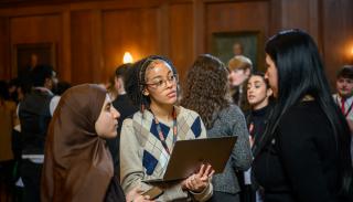 Three woman undergraduate students talking at the BISA 2024 climate sim