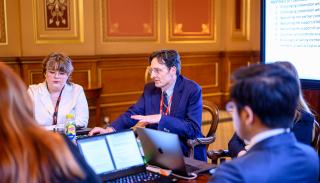 Professor Mark Webber engaging with a small group of students at the Foreign Office