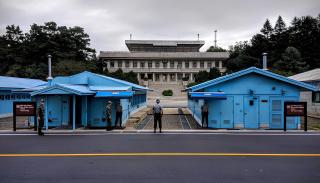 Two sky blue security huts and a guard soldier at the North and South Korean Demilitarized Zone Joint Security Area