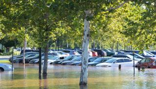A carpark full of cars submerged under flood water