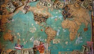 An image of a map with multiple types of currency scattered around the edge.