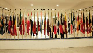 A line up of various countries flags in a hallway