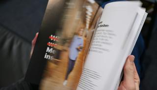 A magazine with text and an image of a person running
