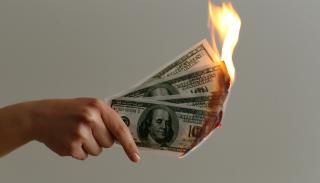 Piece of money on fire