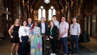 Speakers and organisers of the BISA PG/ECR day 2025 in the atrium at Queen's University Belfast Graduate School