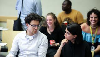 Two students having a conversation at a workshop