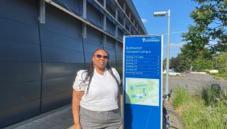 Margaret Ifeoma Abazie-Humphrey outside Southampton University next to a blue University sign