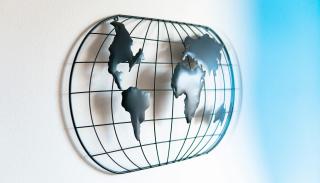 metal abstract globe against white wall