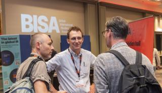 Andrew Dorman speaking with two #BISA2023 delegates at Hilton Glasgow