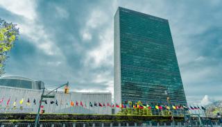 The UN main building and line of flags outside.