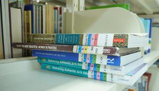 stack of journals on a library shelf