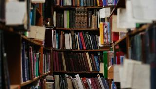 Shot of a set of library shelves with multicoloured books.