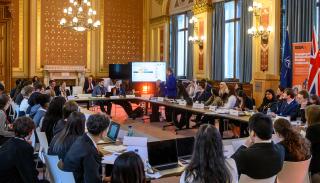 A group of students around a table at FCDO for BISA/FCDO Model NATO 2025