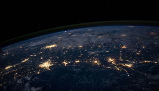 Arial shot of the earth at night with lights lit up on the earth 