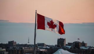City skyline with a Canadian flag and a sunset 