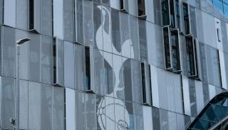 Tottenham stadium with the logo on the side