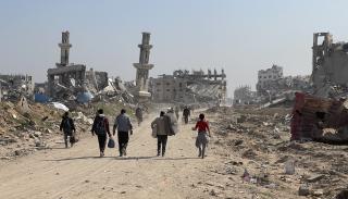 Displacement of Gaza Strip residents walking through a bombed area