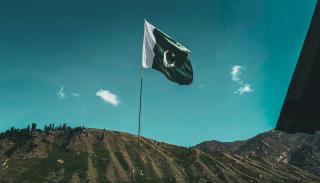 Pakistani flag flying over a mountain