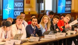 Students sat around a table at the 2026 BISA/FCDO Model NATO