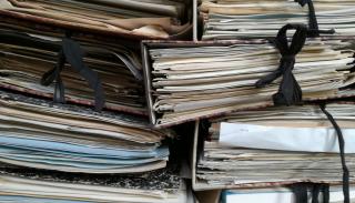 Multiple large stacks of bound together papers