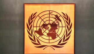 Gold and brown painting of the United Nations logo 