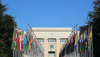 UN headquarters with a line of countries flags leading to the entrance