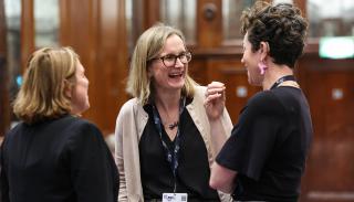 3 women laughing in a circle