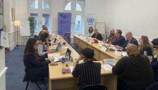 Participants round a table at the BISA policy lab on AI