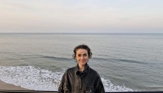 Alice Finden on the beach wearing a leather jacket