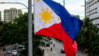 close up shot of a Filipino flag waving above a street