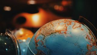 close up shot of a globe in a warmly lit room 