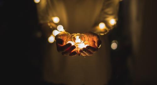 Hands holding a string of lights