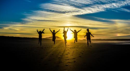 Five people jumping for joy