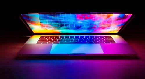 A half-closed laptop with a multi-coloured screen