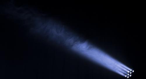 Spotlight shining against dark background.
